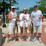 3 people holding their fish