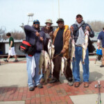 group of men after charter excited about their catch