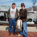 man and his son with their catch of the day