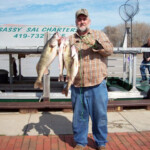 man holding his 4 freshly caught fish