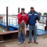 two men holding their charter catch