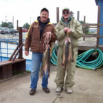 two men holding a fresh catch